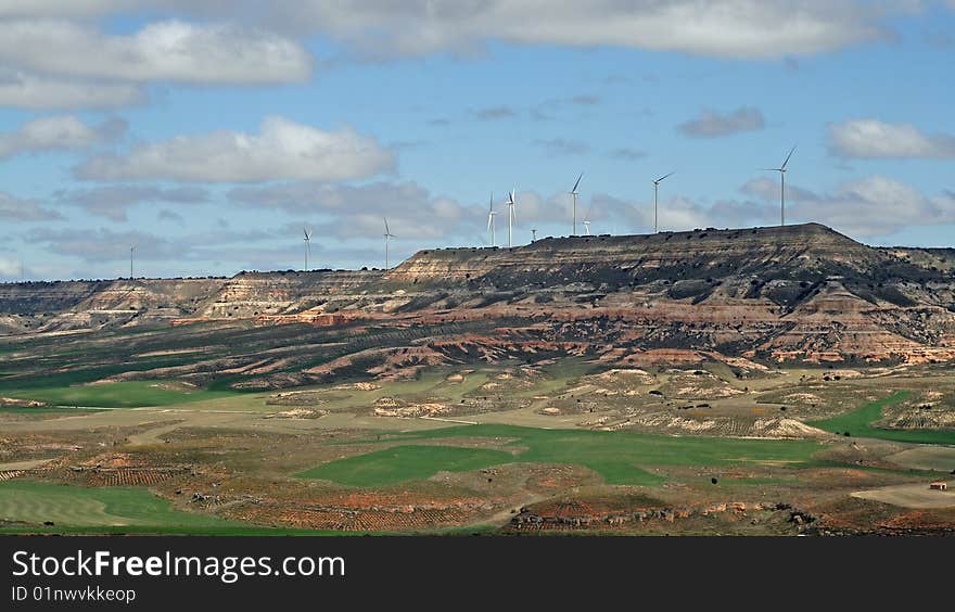 Wind turbines against the sky in fields of Spain