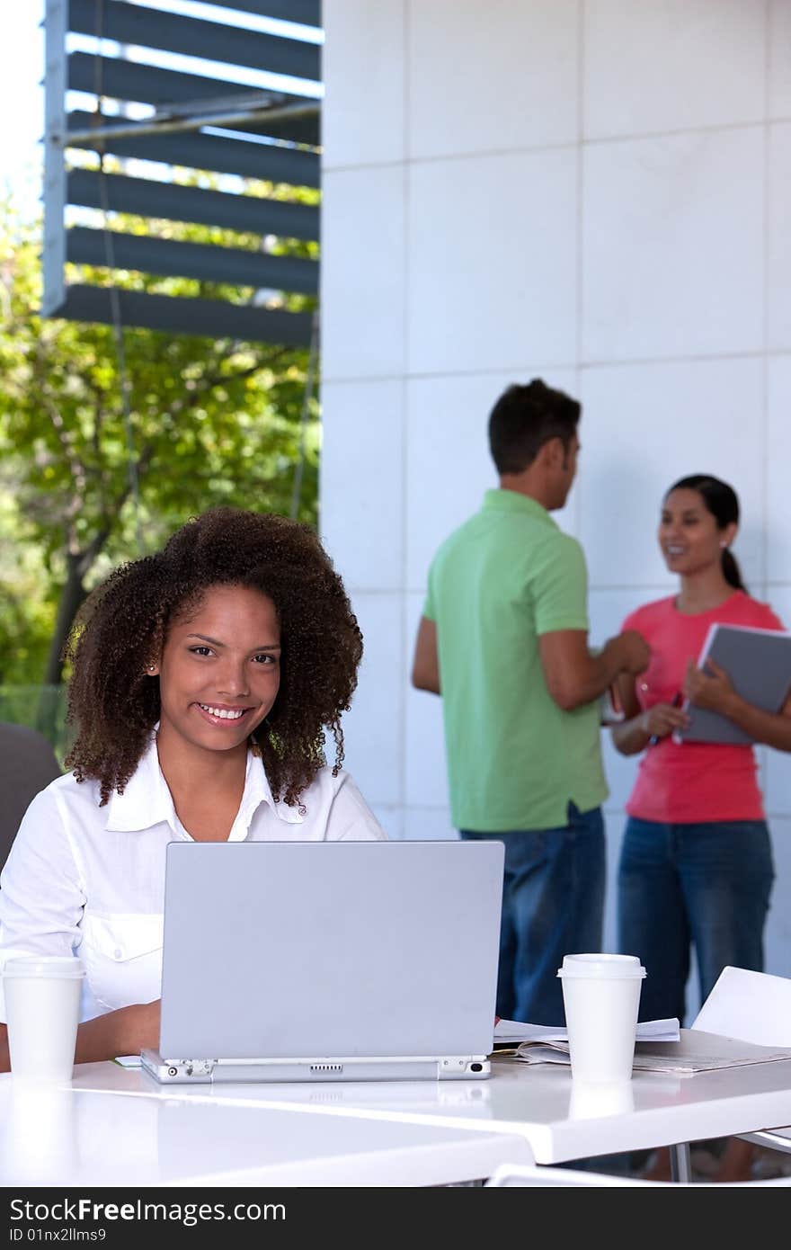 Portrait of female student working on laptop.