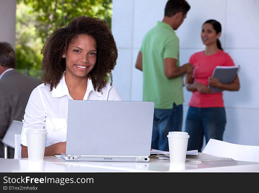 Portrait of female student working on laptop. Portrait of female student working on laptop.