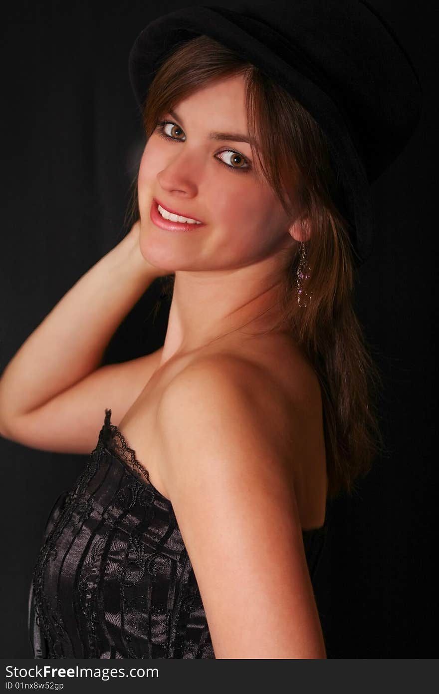 Young beautiful girl in a corset with an hat