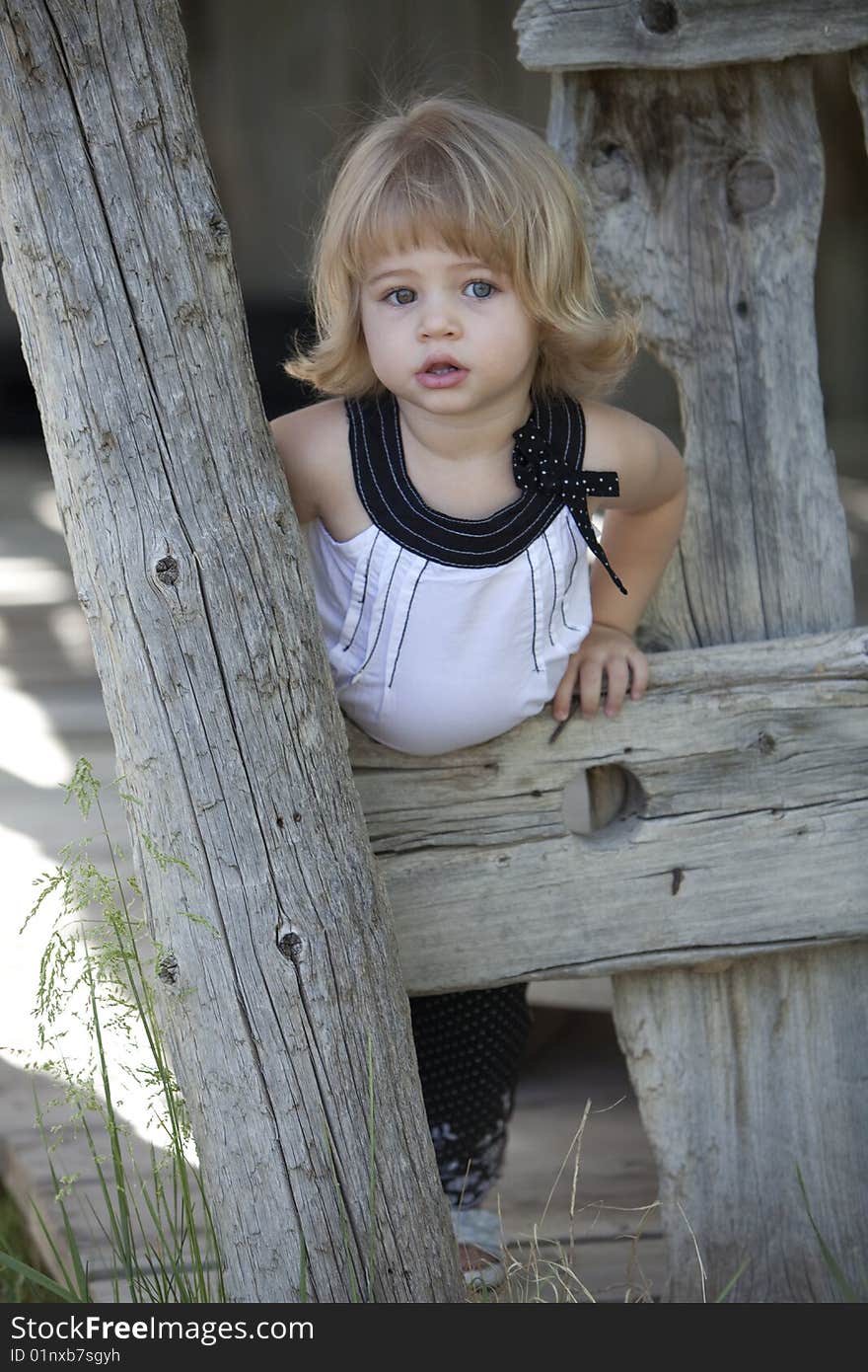 Little girl in barn with white top on. Little girl in barn with white top on