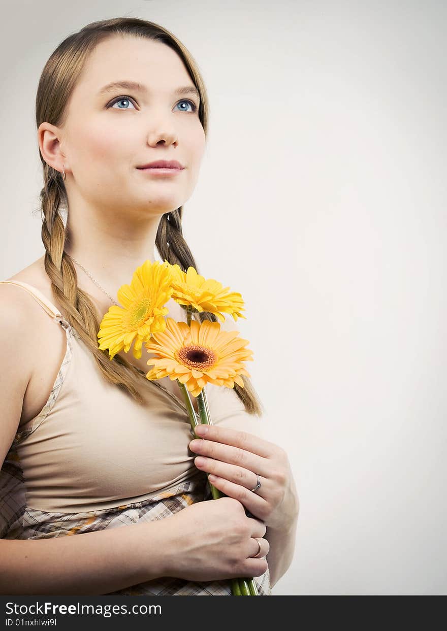 Sensual girl with yellow flowers looking up. Sensual girl with yellow flowers looking up