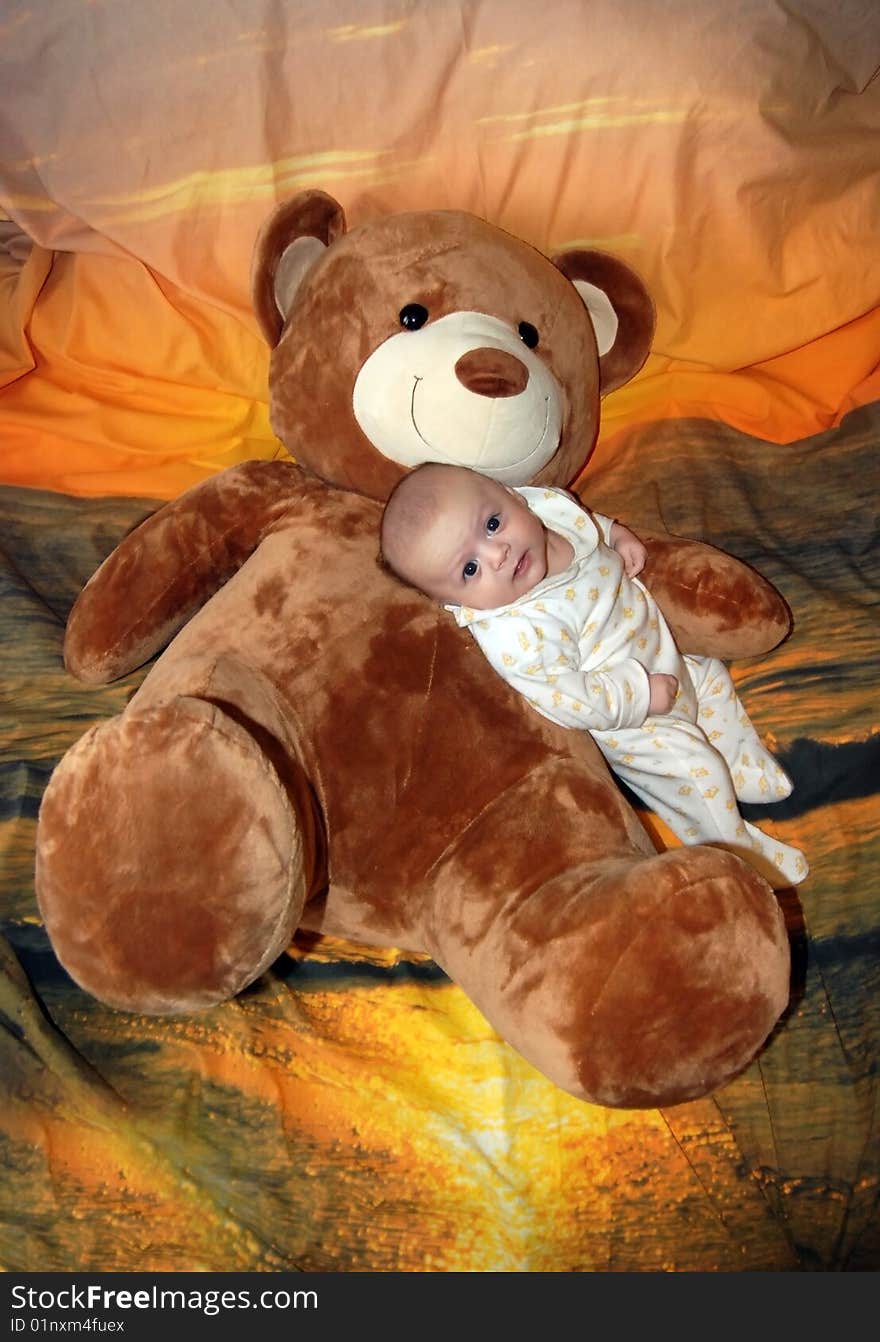 Infant baby boy with big bear toys. Infant baby boy with big bear toys