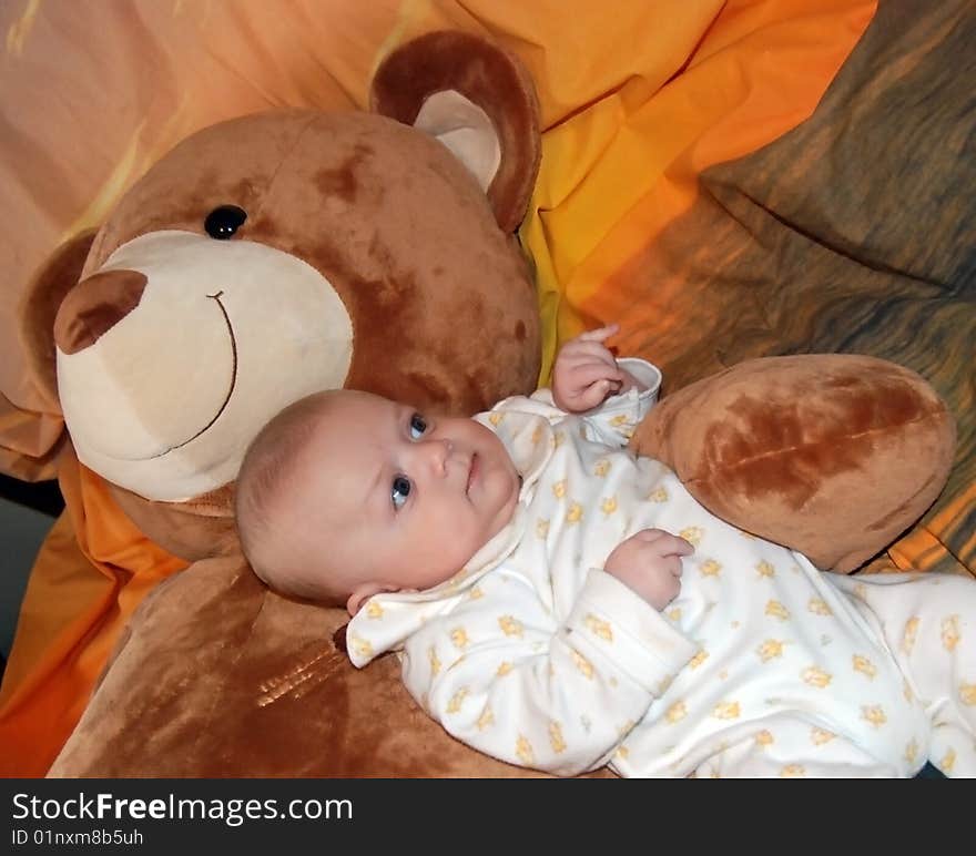 Infant baby boy with big bear toys. Infant baby boy with big bear toys