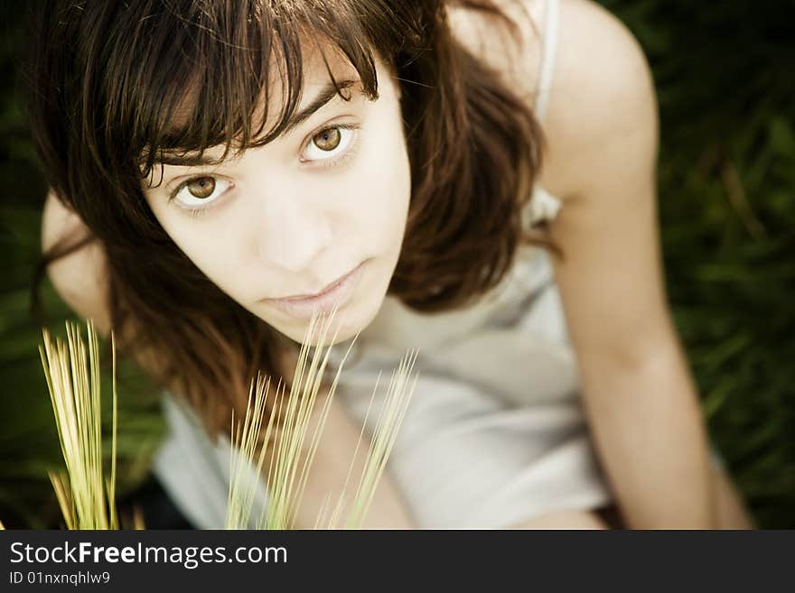 Young sitting woman staring at camera from below. Young sitting woman staring at camera from below