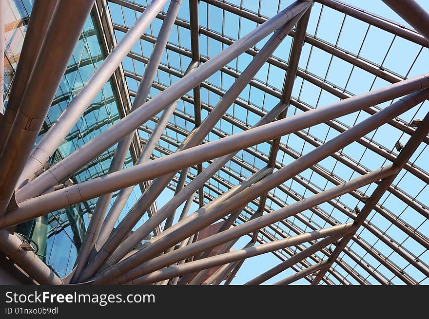 Glass roof of the building over blue sky