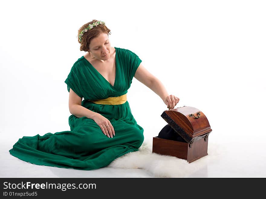 Lady in green antique dress opening box on white background. Lady in green antique dress opening box on white background