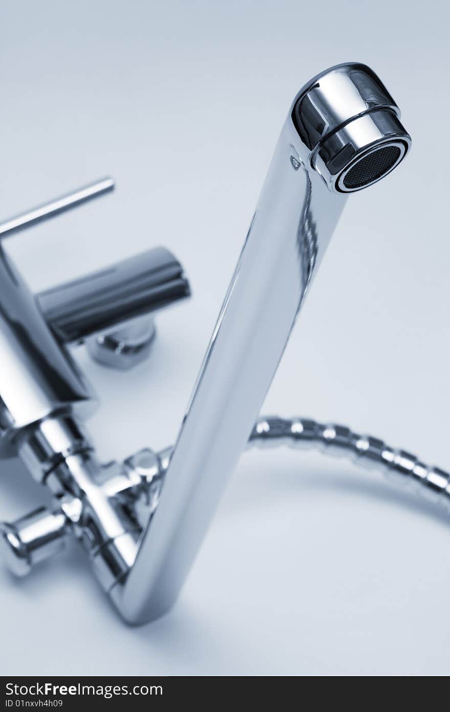 Modern metal faucet and shower close up