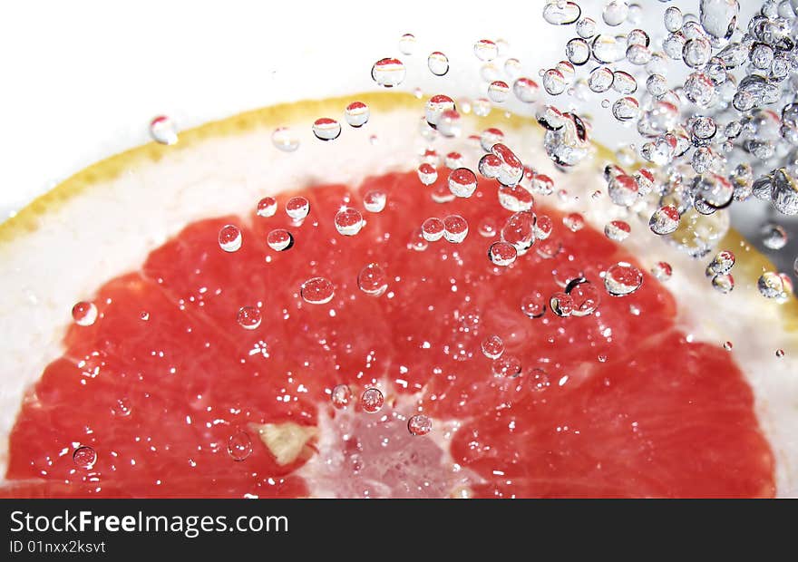 Red grapefruit and splashing water. Red grapefruit and splashing water.