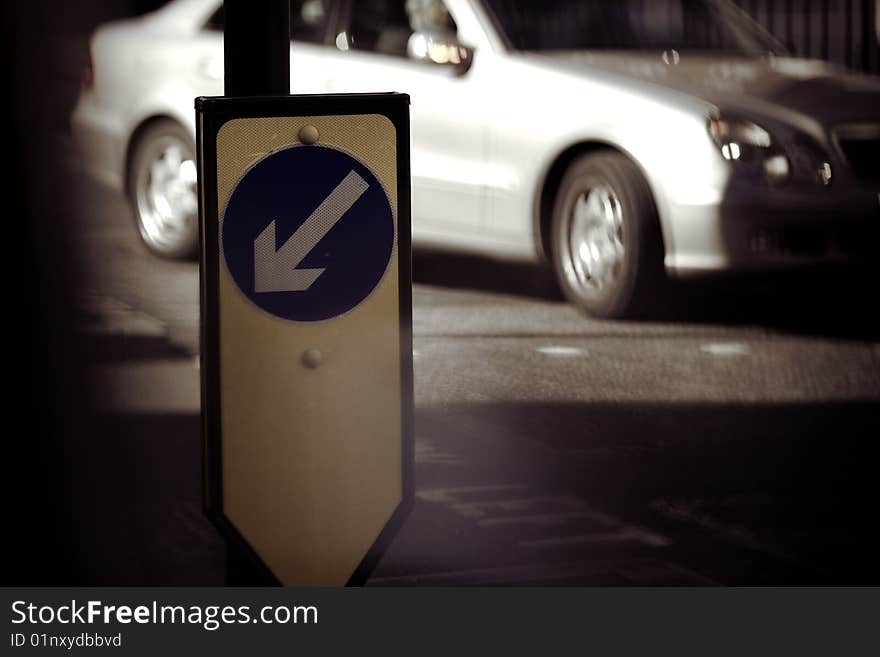 European traffic sign with a luxury sedan in the background