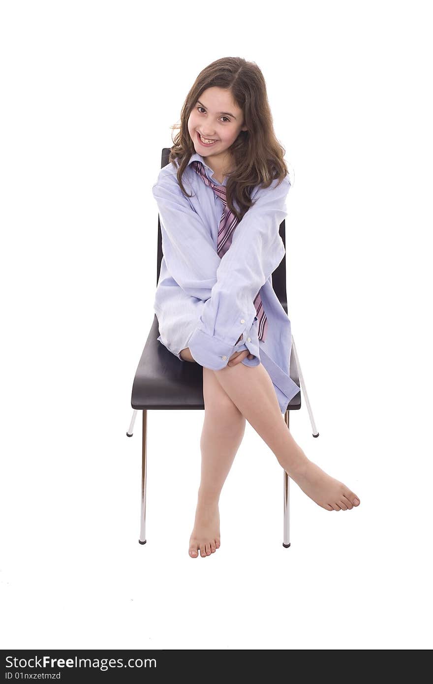 A young girl is playing with shirt and adult tie. A young girl is playing with shirt and adult tie