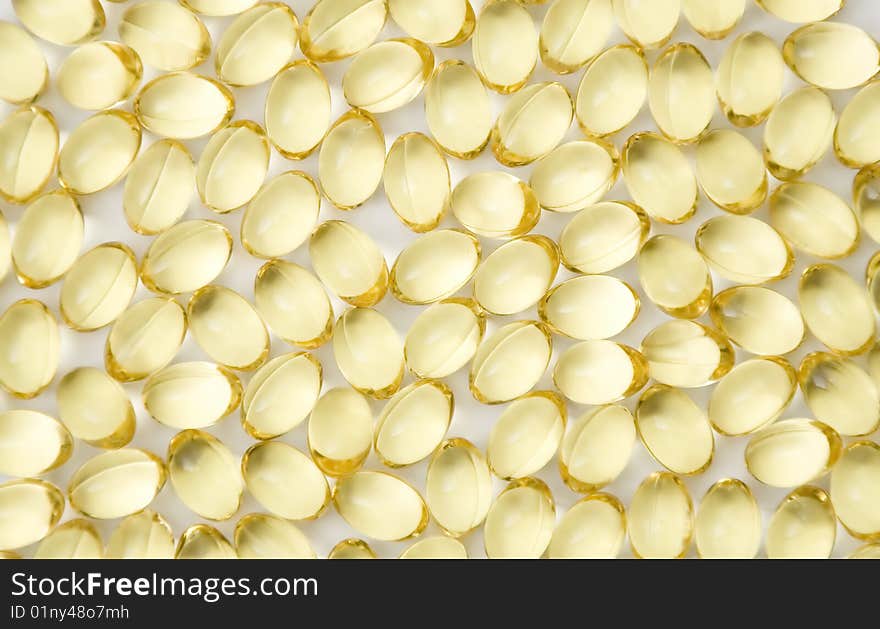 Caplets with fish oil over white background. Caplets with fish oil over white background