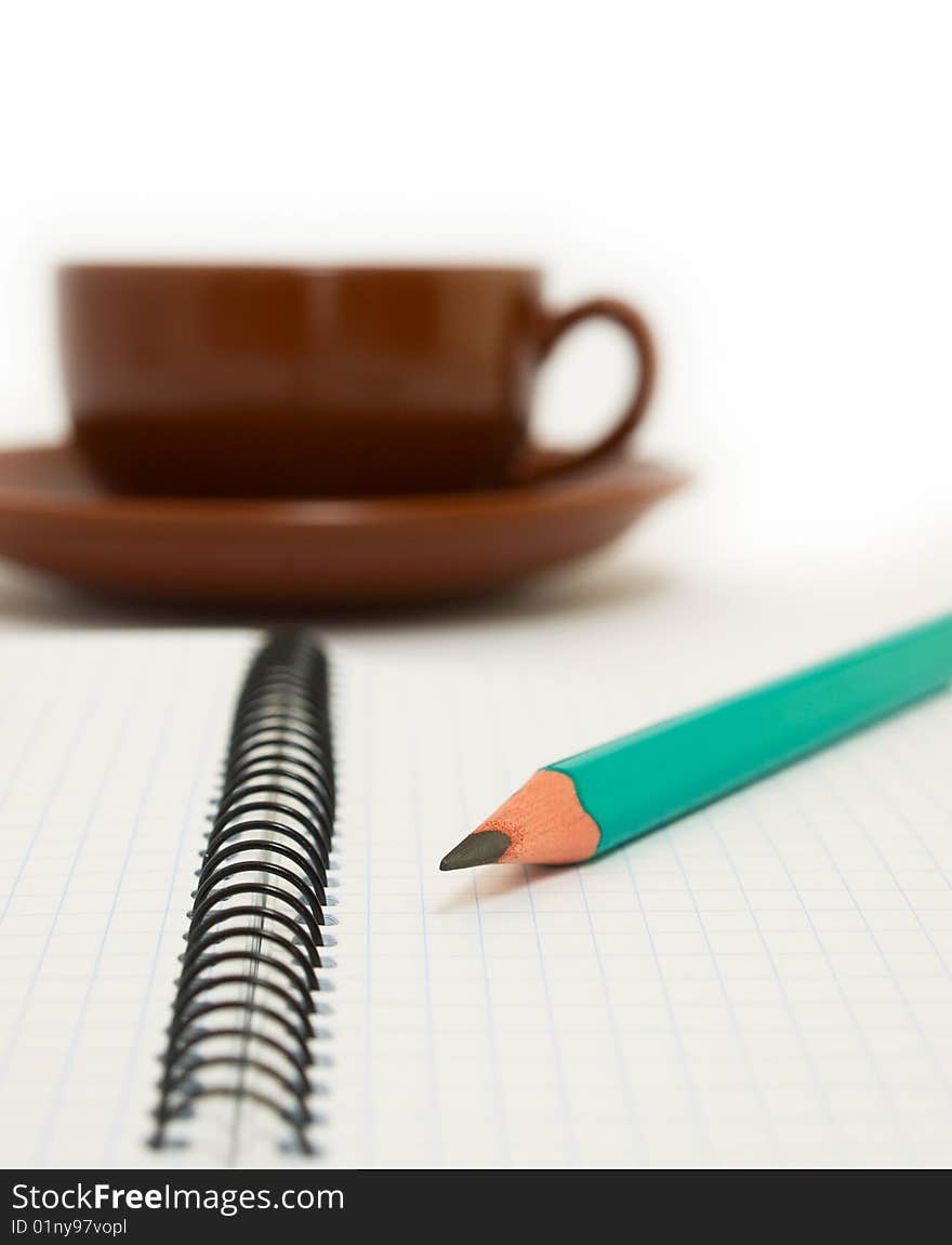 Green pencil rests on the paper. Green pencil rests on the paper