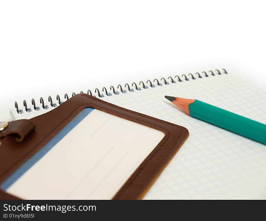 Green pencil rests on the paper. Green pencil rests on the paper