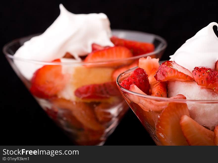 Strawberry shortcake in a martini glass sponge cake and whip cream