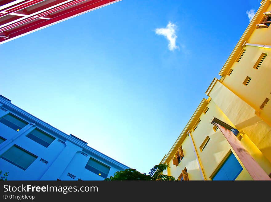 Three walls in differnt colour under the blue sky