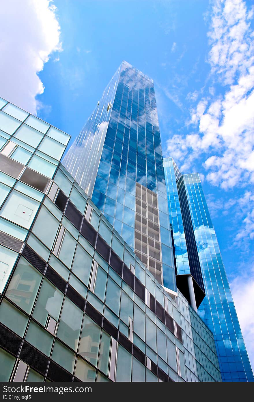 Tall blue building under the bright blue skies