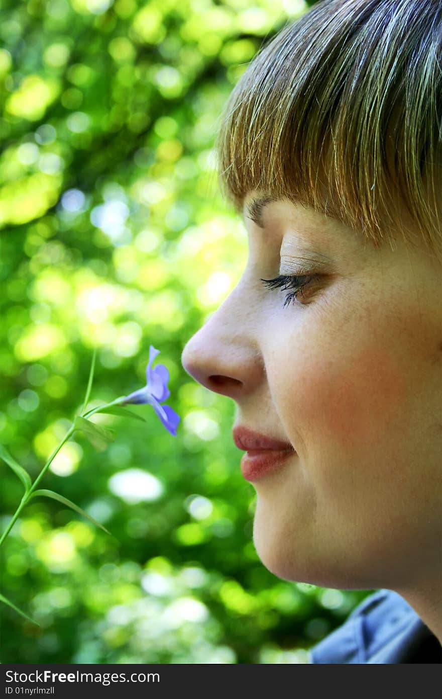 Woman are smelling a flower. Woman are smelling a flower