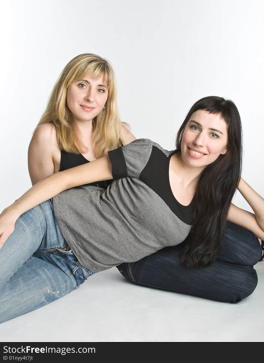 Two young girlfriends isolated on white background. Two young girlfriends isolated on white background