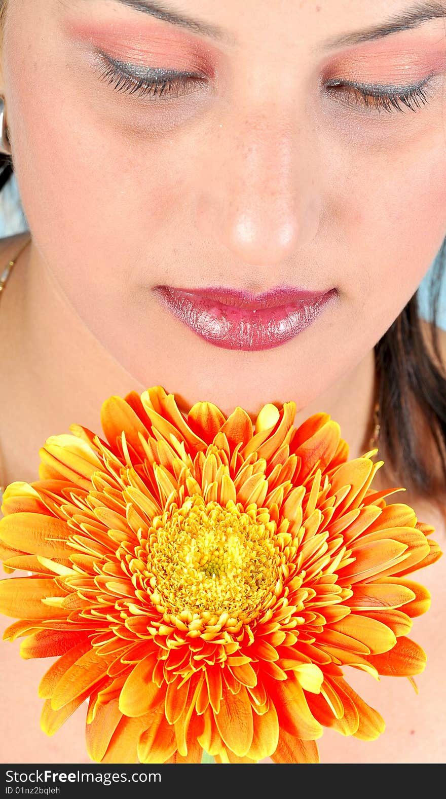 Girl with beautiful smile and orange flower looking beautiful. Girl with beautiful smile and orange flower looking beautiful