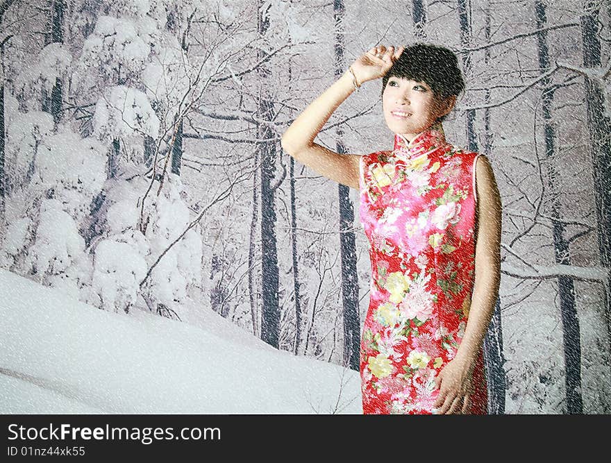 A Chinese girl in traditional dress is on the snow scenes background. A Chinese girl in traditional dress is on the snow scenes background.