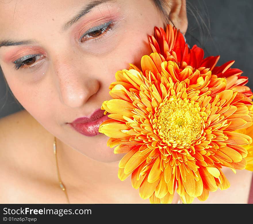 Girl with flower looking beautiful in studio.