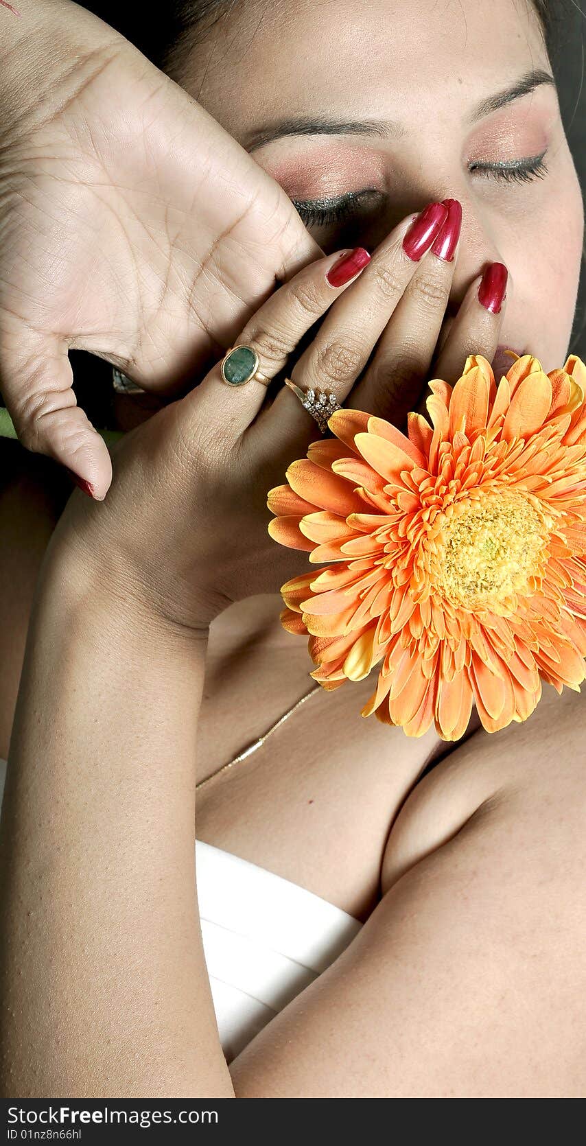 Girl with flower looking beautiful in studio.