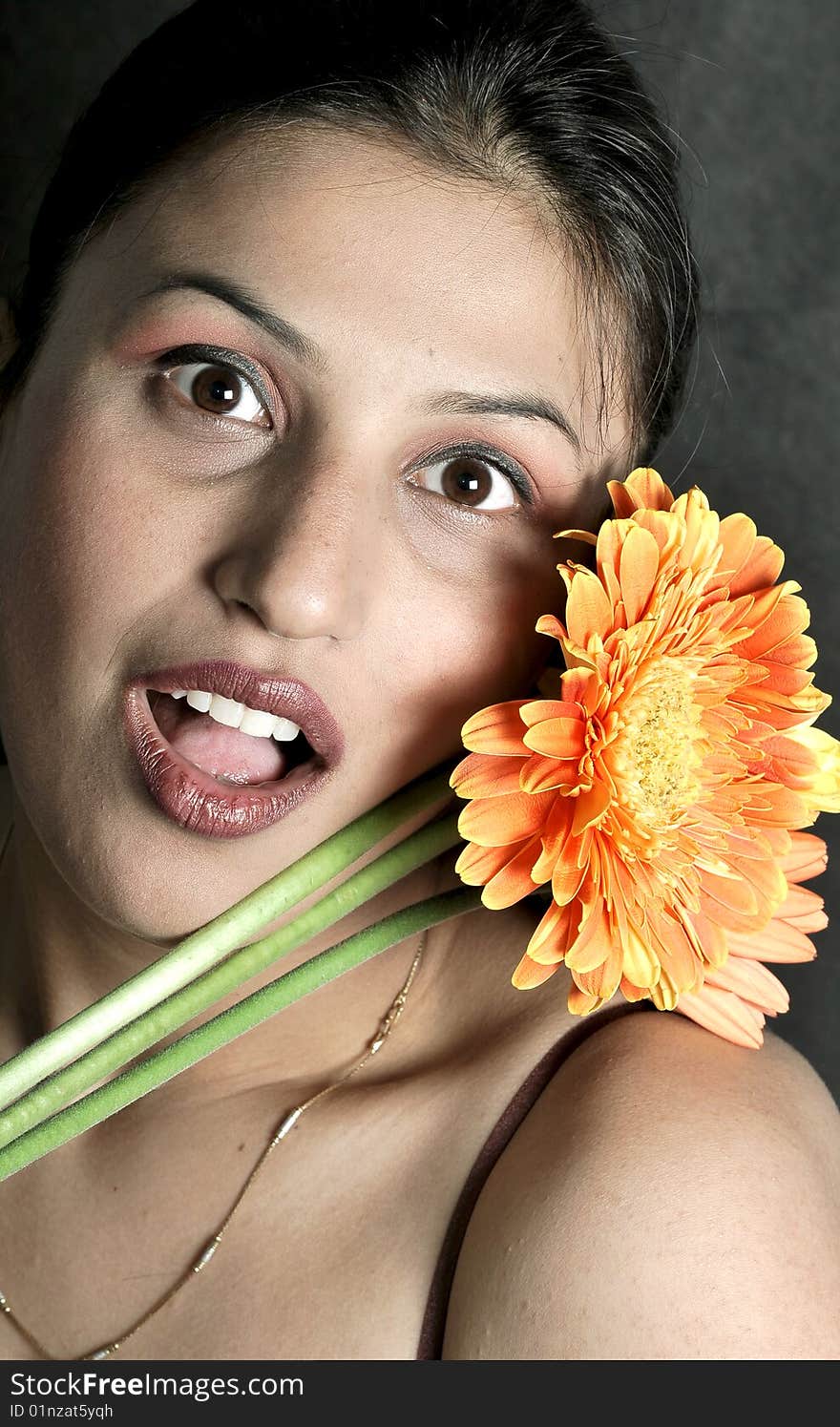 Girl with flower looking beautiful in studio.