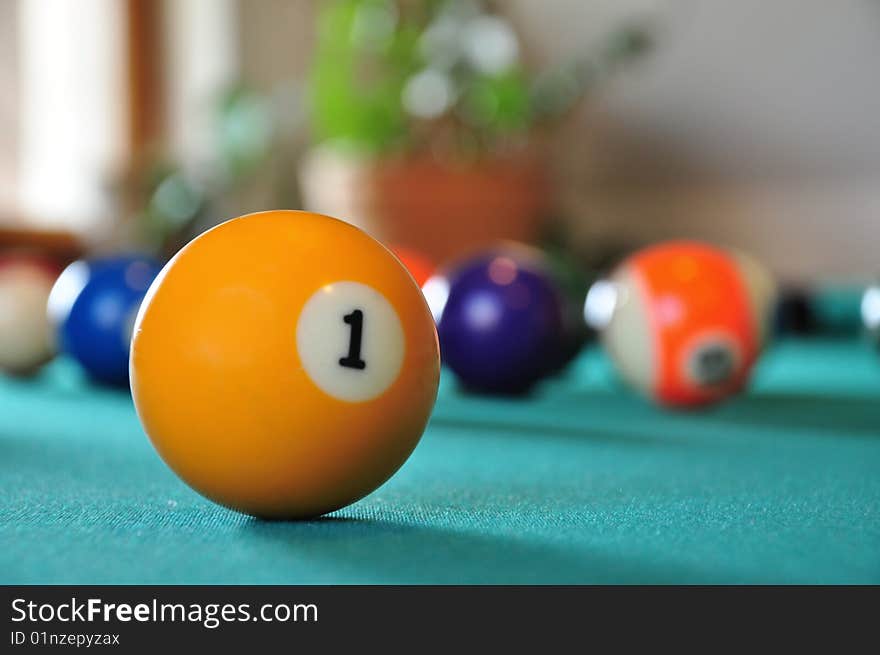 Billiard ball on a billiard table, several balls in blurry background. Billiard ball on a billiard table, several balls in blurry background