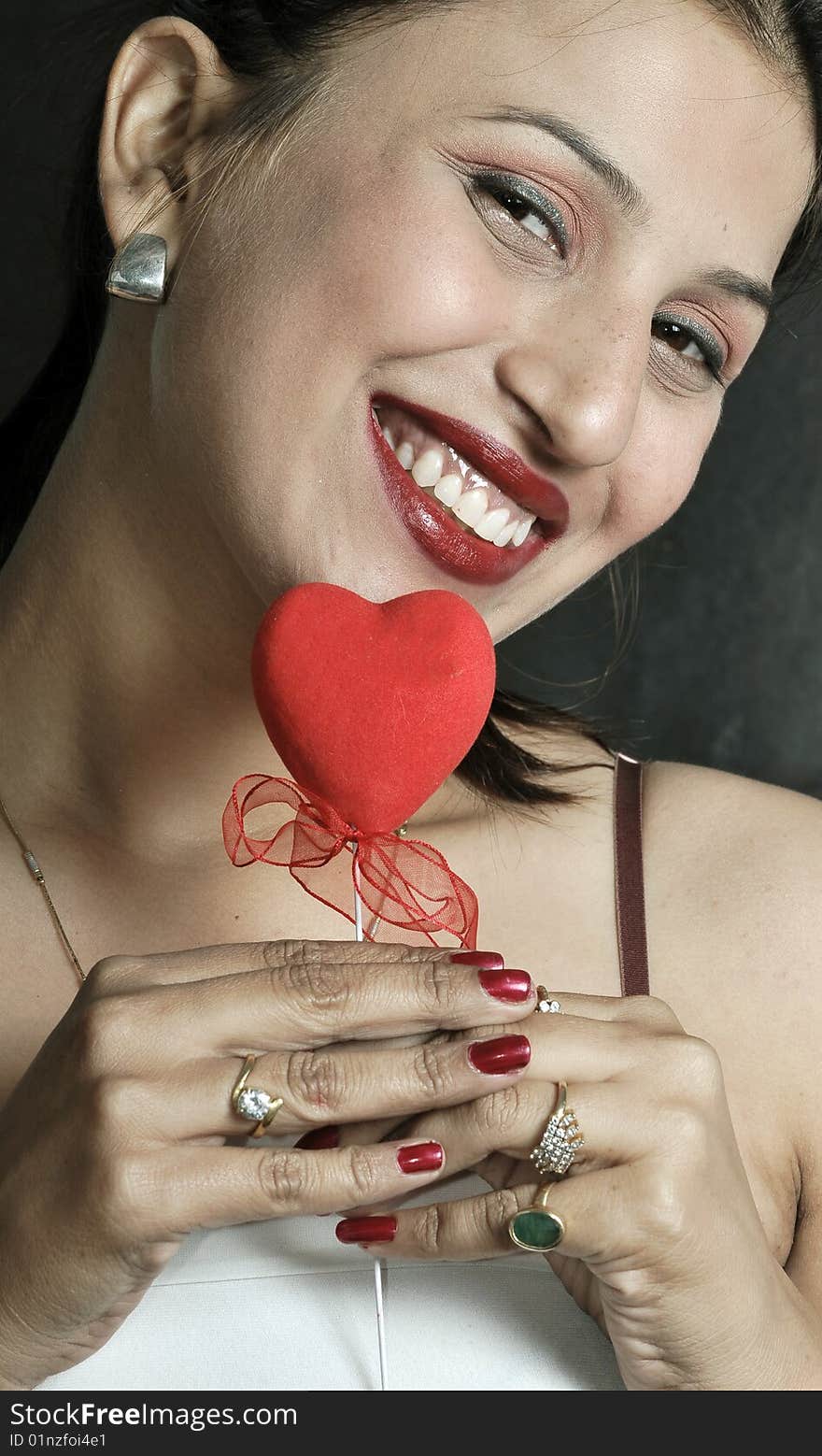 Girl with heart looking beautiful in studio.