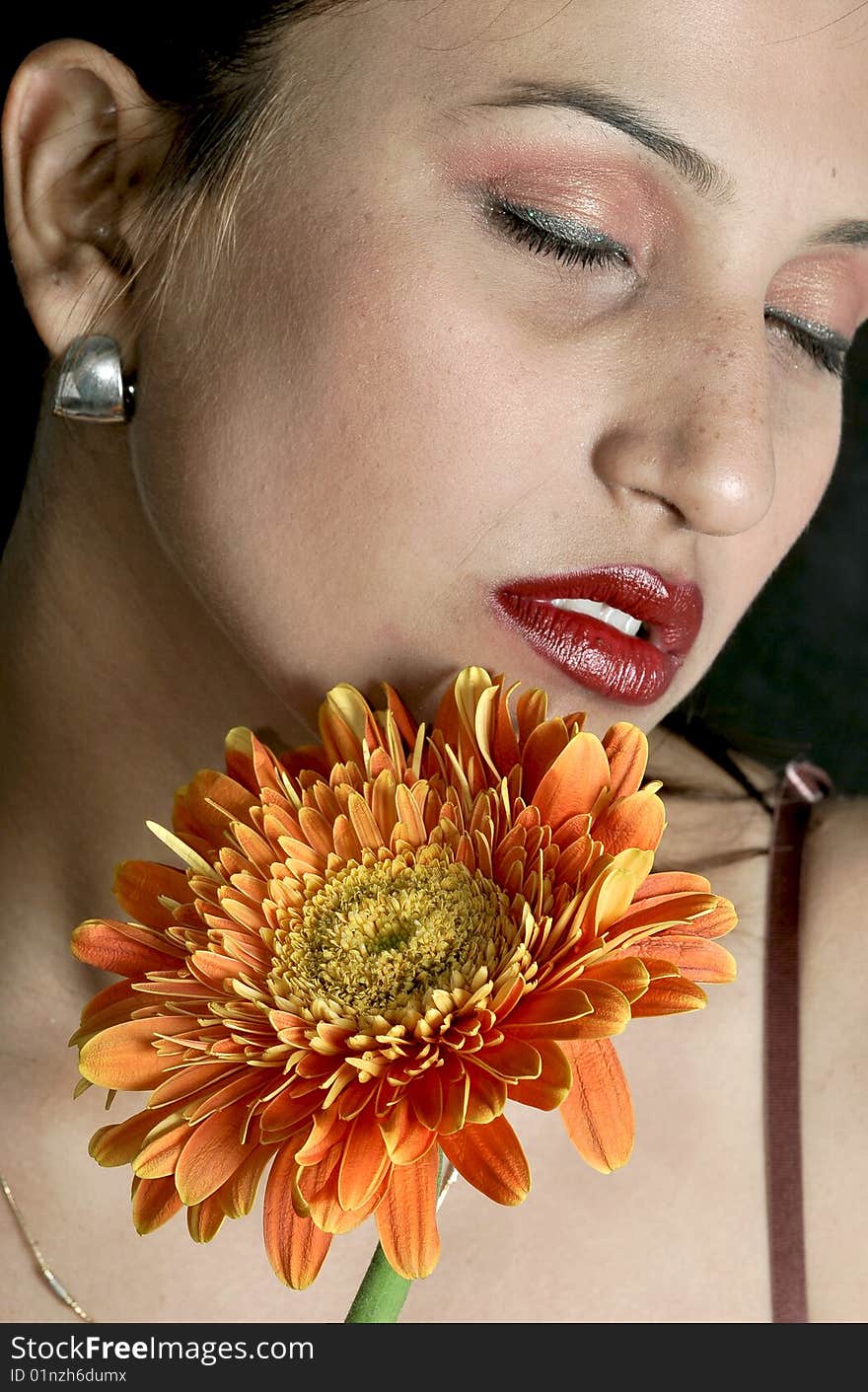 Girl with flower looking beautiful in studio.