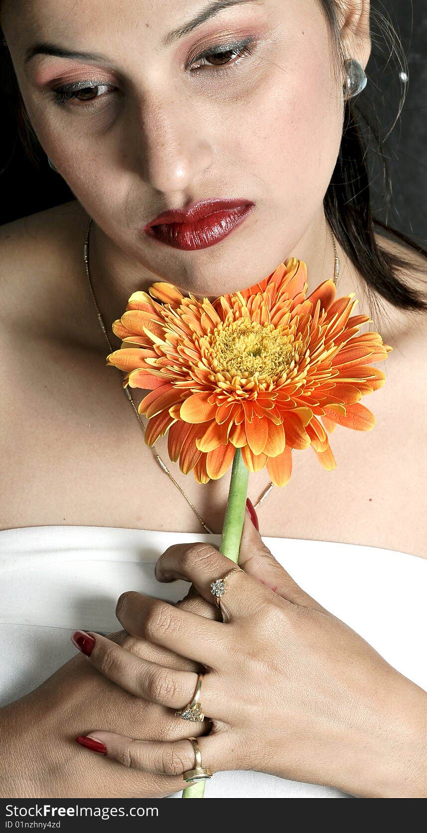 Girl with flower looking beautiful in studio.