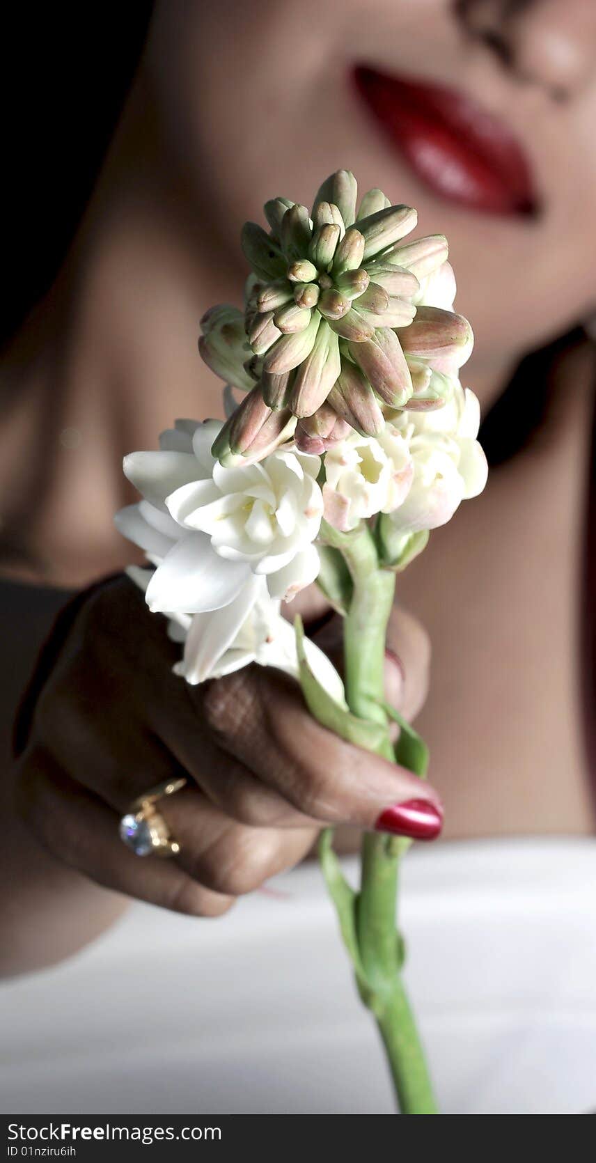 Girl with beautiful smile holding white flowers looking beautiful. Girl with beautiful smile holding white flowers looking beautiful