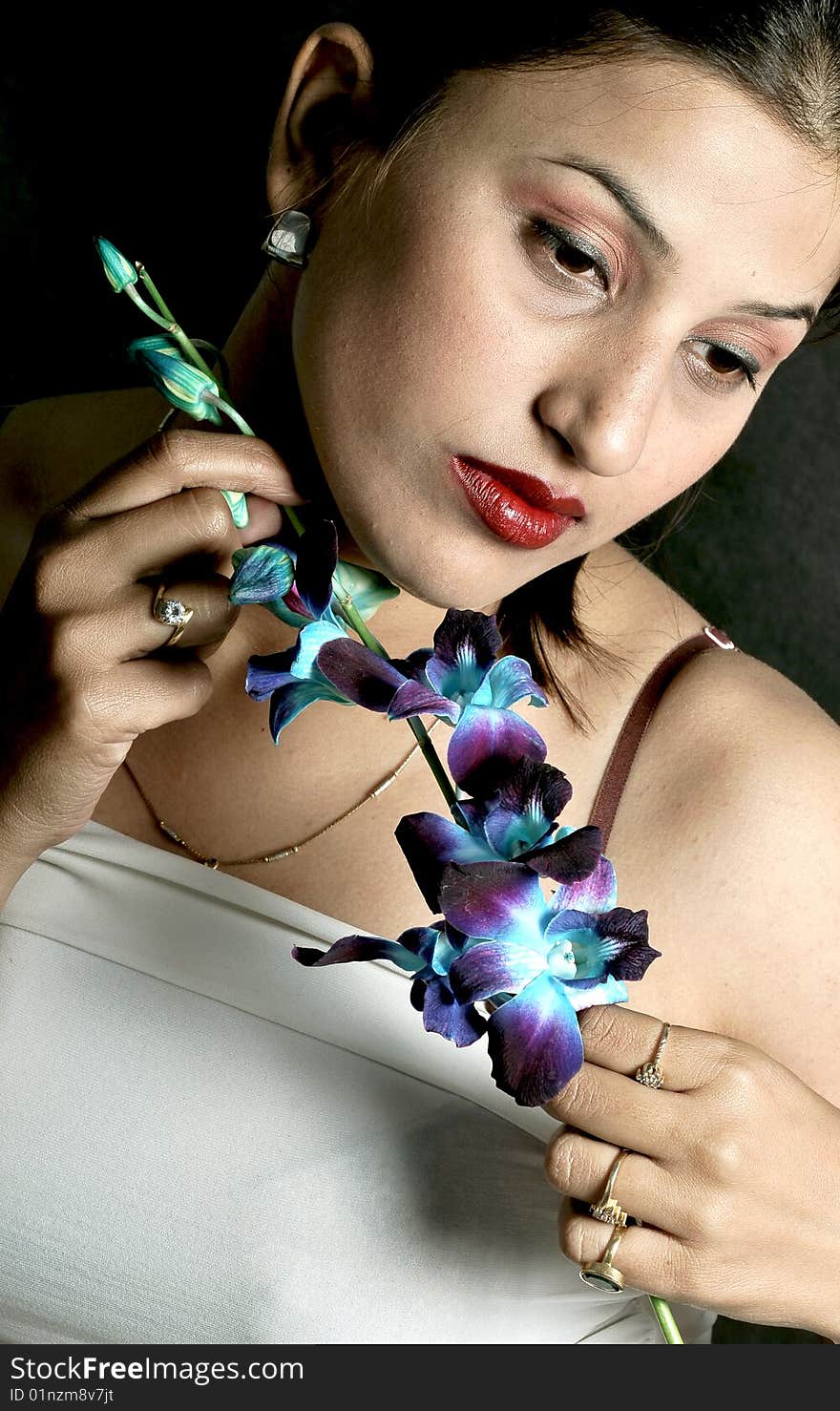 Girl with flower looking beautiful in studio.