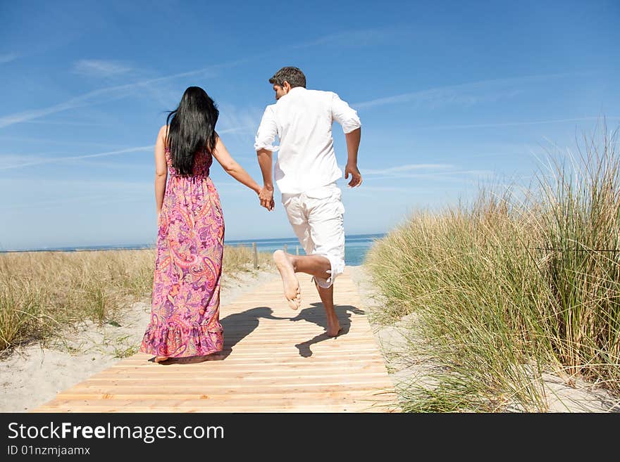 Couple running to the beach. Couple running to the beach