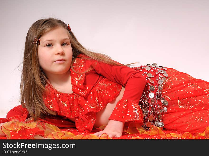 Portrait of a small gipsy girl dressed with red clothes