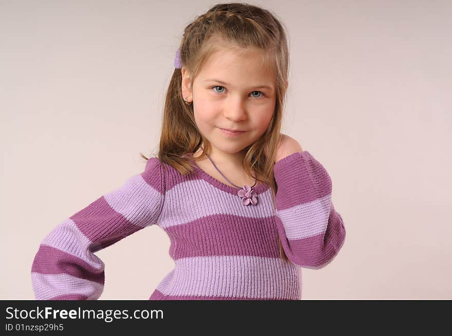 Close up with small, smiling girl with her hand in hair. Close up with small, smiling girl with her hand in hair