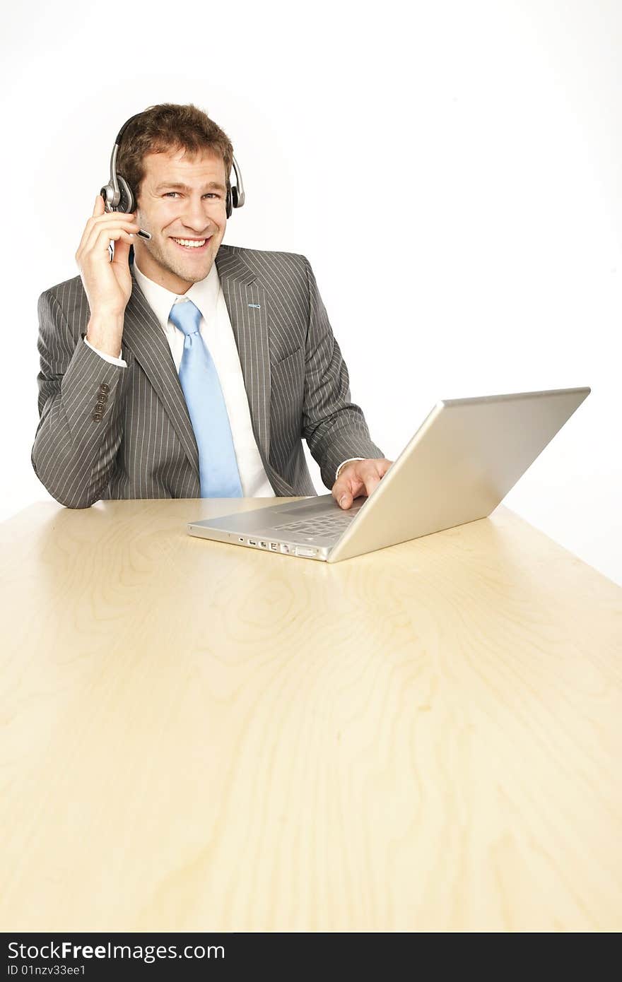 Businessman with headphones and laptop on telesale center. Businessman with headphones and laptop on telesale center