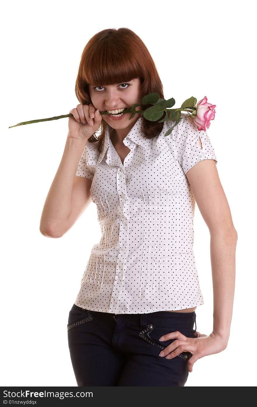 The girl holds a rose in a teeth on a white background. The girl holds a rose in a teeth on a white background