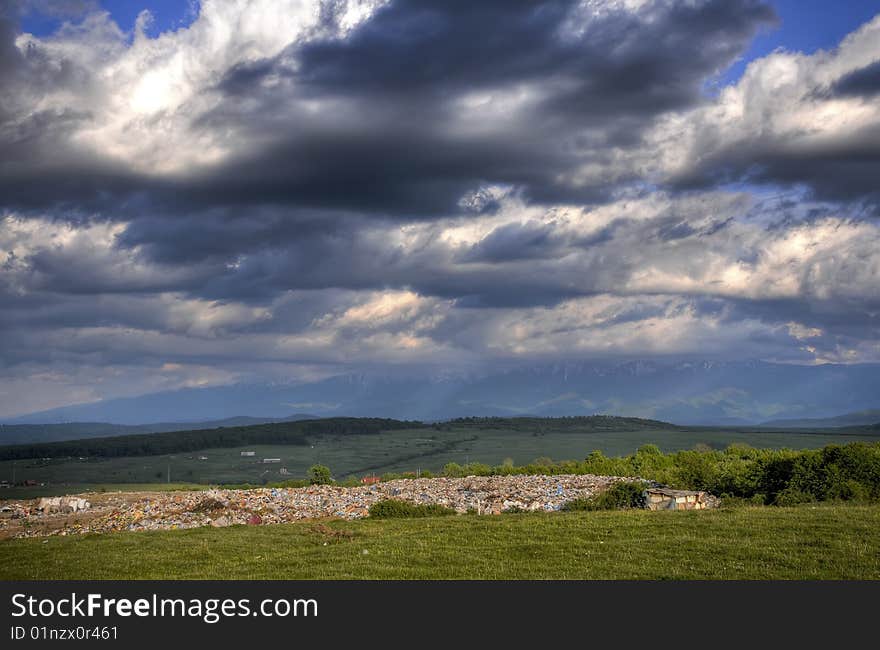 Landscape with dramatic sky and large junk yard. Landscape with dramatic sky and large junk yard