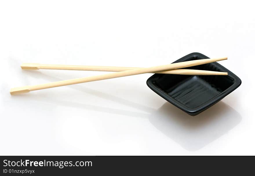 Chopsticks and a wasabi dish isolated