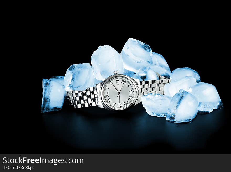 Watch and ice on black background. Watch and ice on black background