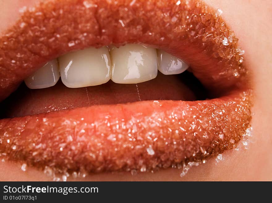 Woman's red lips coated with scattered sugar. Woman's red lips coated with scattered sugar