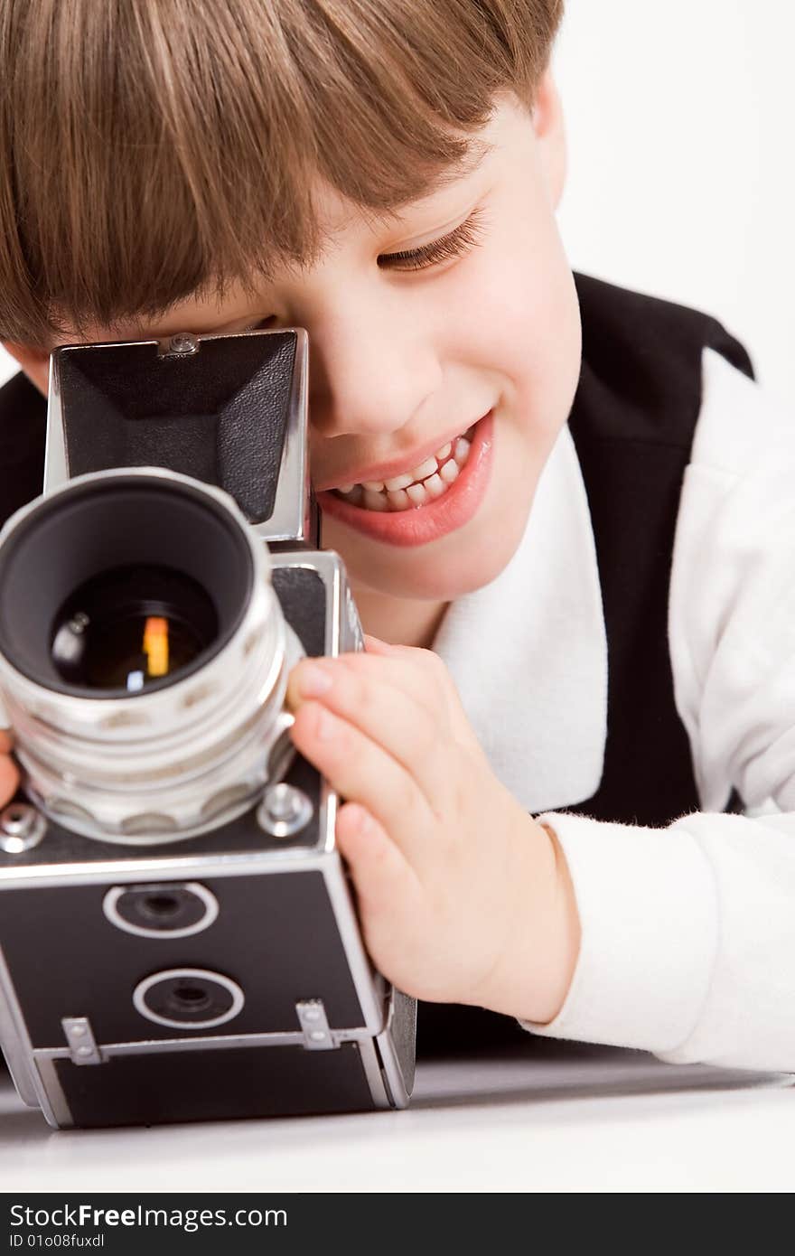 Attractive little boy with photo camera over white. Attractive little boy with photo camera over white