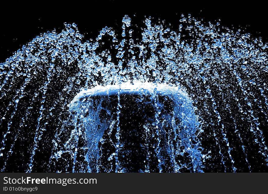 Sparks of blue water on a black background