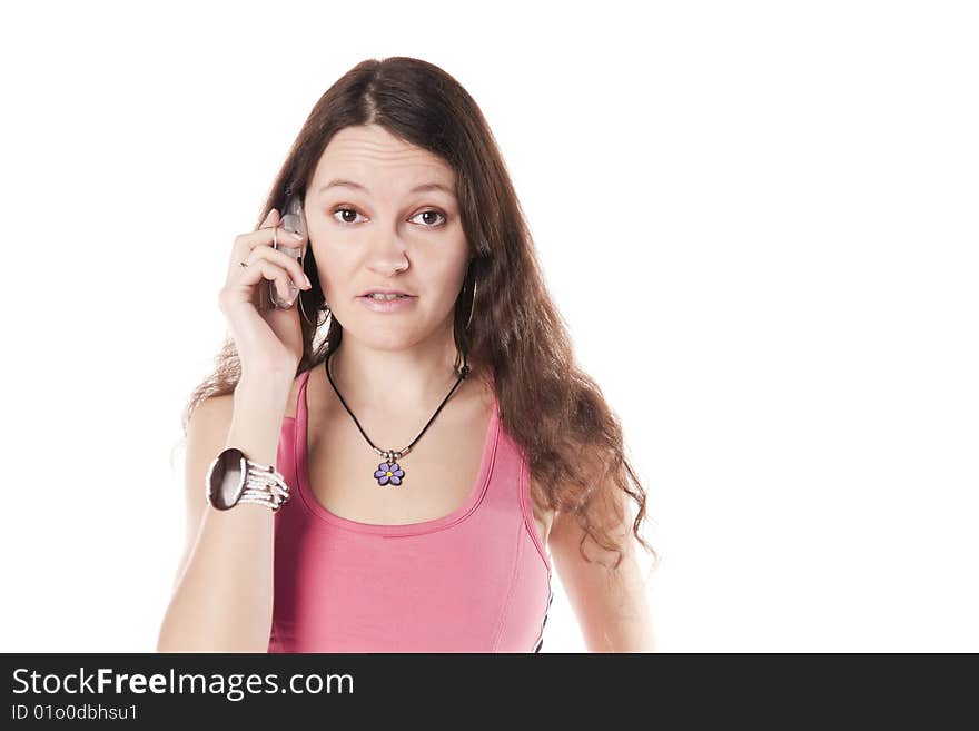 The girl speaks by a mobile phone. Isolated over white. The girl speaks by a mobile phone. Isolated over white.