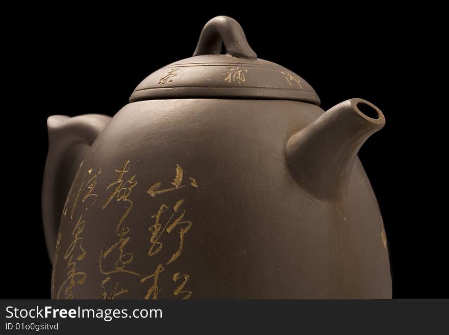 Half of teapot  with clipping path over black background. Half of teapot  with clipping path over black background