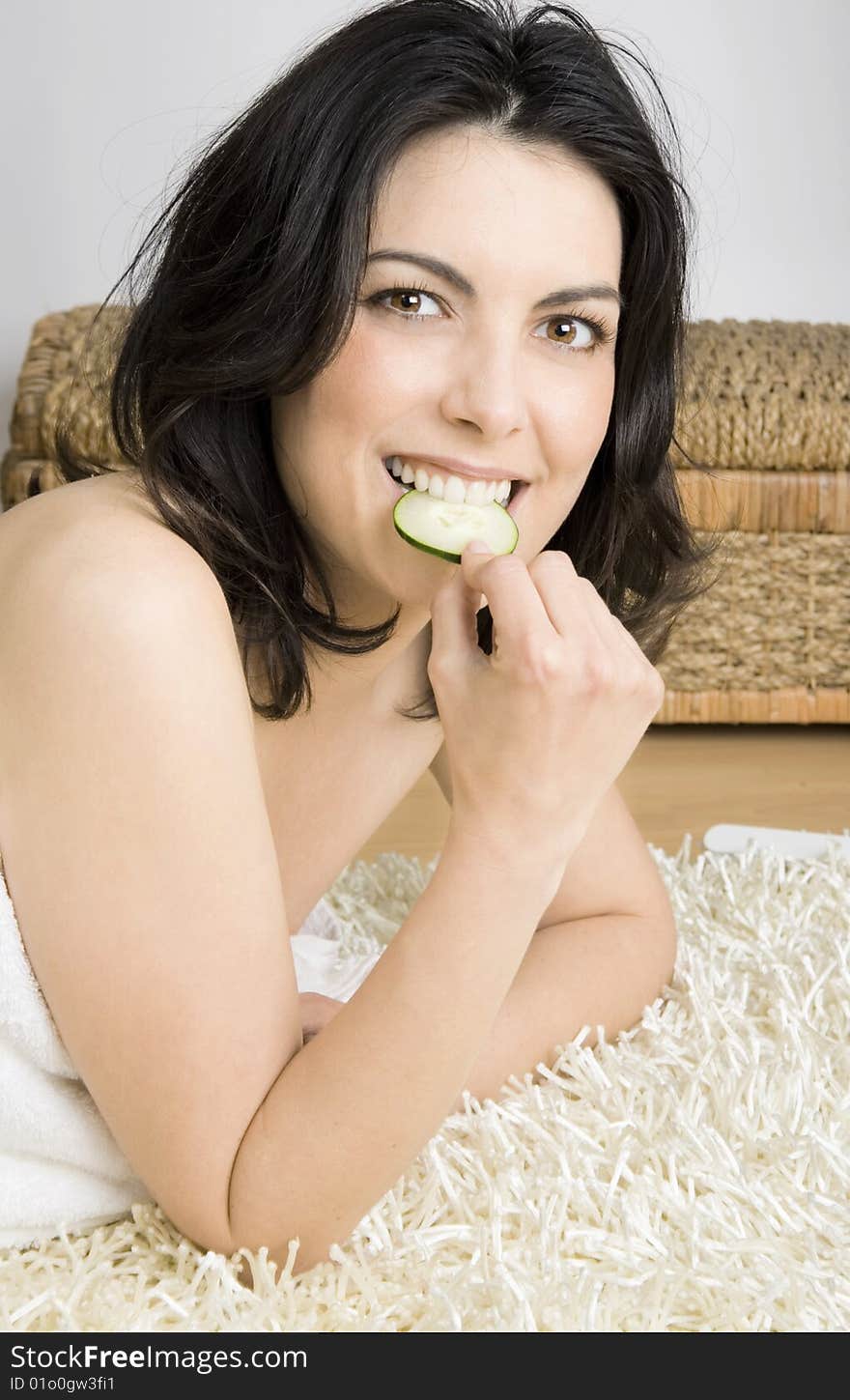 Young, beauty woman relaxing and eating cucumber