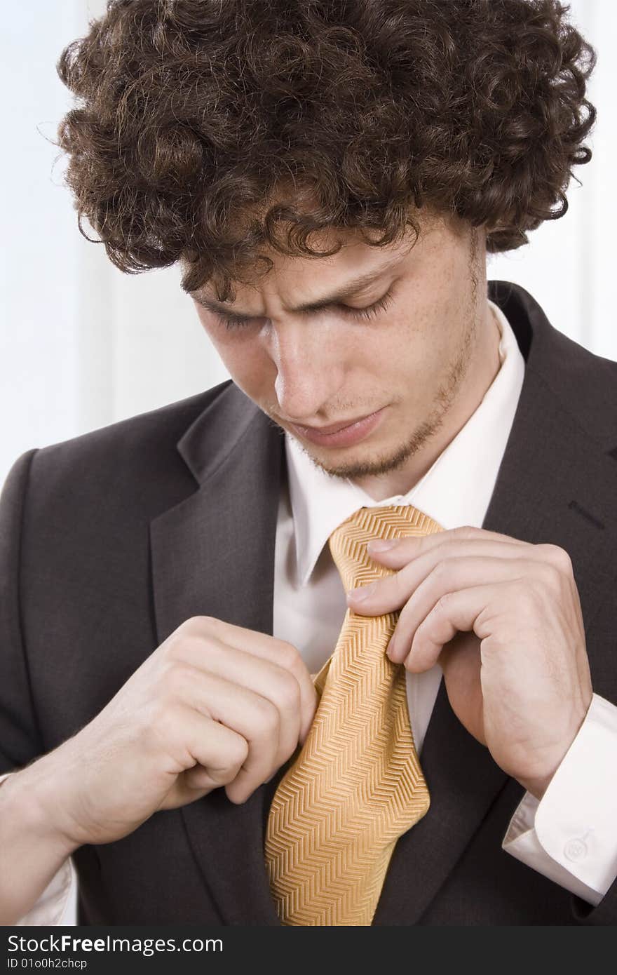 Business man resses his scarf in the office