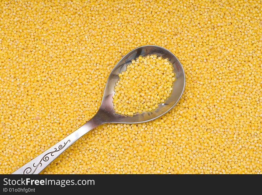 Millet background, yellow small groats, close-up, cooking ingredients